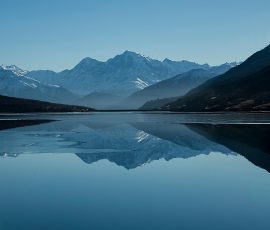 Snow-capped mountains reflected in a calm alpine lake mountain lake foogallery sample image 1